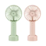 DP-7631 Rechargeable Mini Handheld Fan with detachable base on a desk, blowing cool air, compact design with 2000mAh battery.